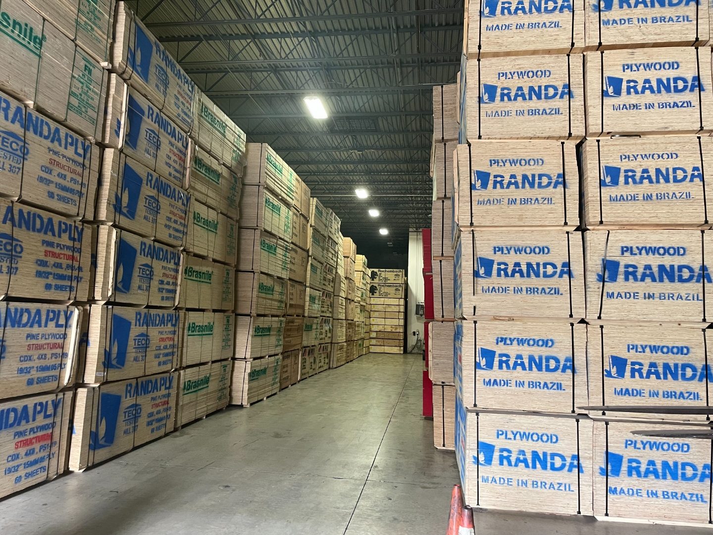 International Plywood and Discount Forklifts signs visible at yard entrance with lumber and plywood stacks
