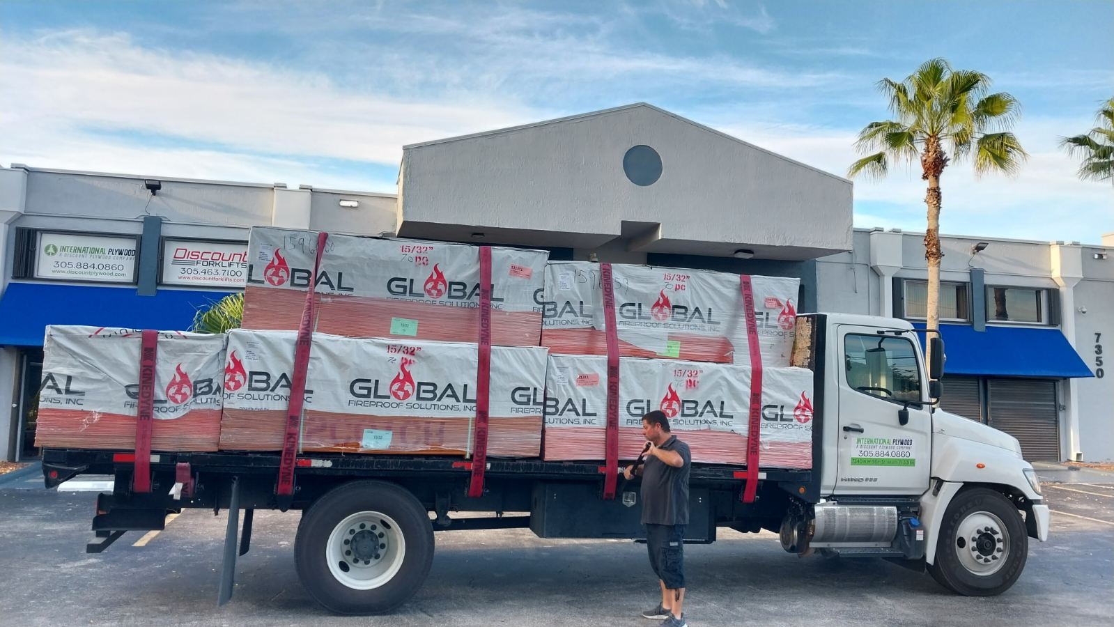 International Plywood truck loaded with Global Fireproof Solutions FRT plywood ready for delivery in front of Doral HQ