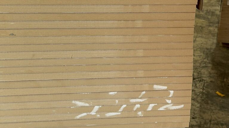 Stacked MDF sheet edges in the International Plywood & Lumber Doral warehouse